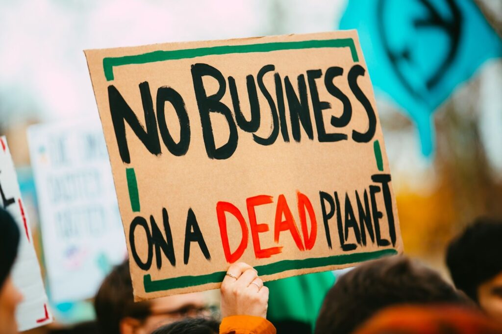 NO BUSINESS ON A DEAD PLANET. Climate change chaos strike demonstration protest: https://unsplash.com/photos/no-business-on-a-dead-planet-sign-z56L143KBvE