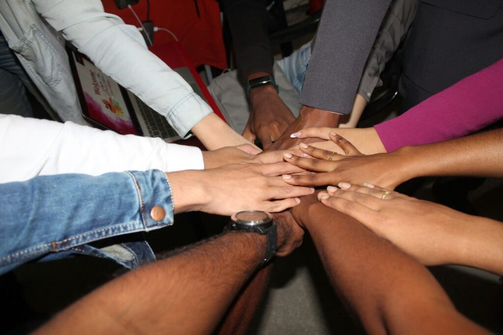 A group of multicultural hands in a huddle. 